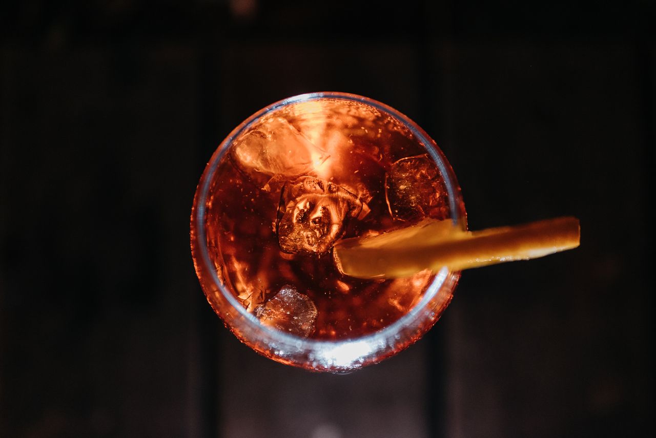 Orange aperitif drink with ice and citrus garnish