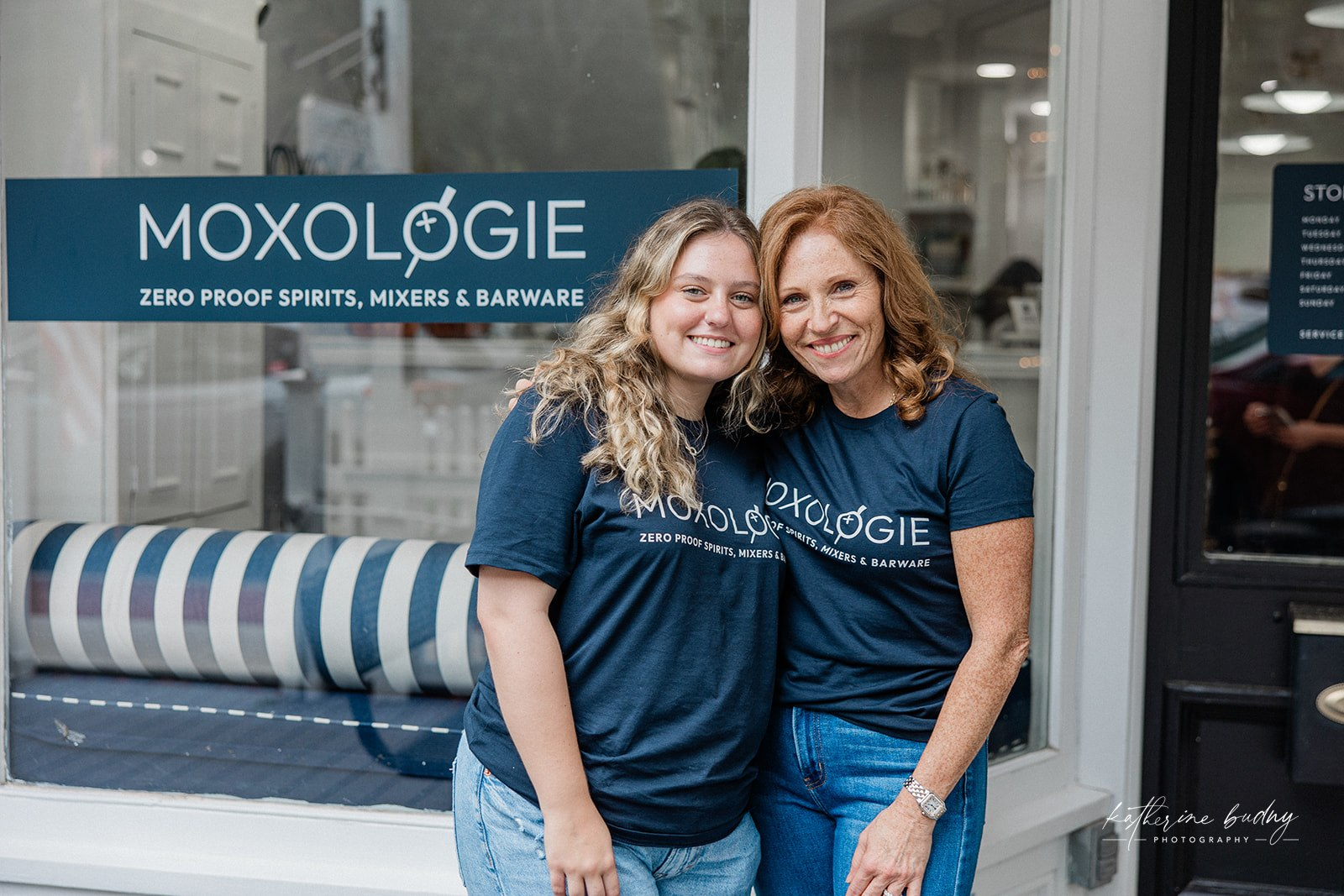 Suzanne Ettinger, co-owner of Moxologie, posing in front of the store with her daughter